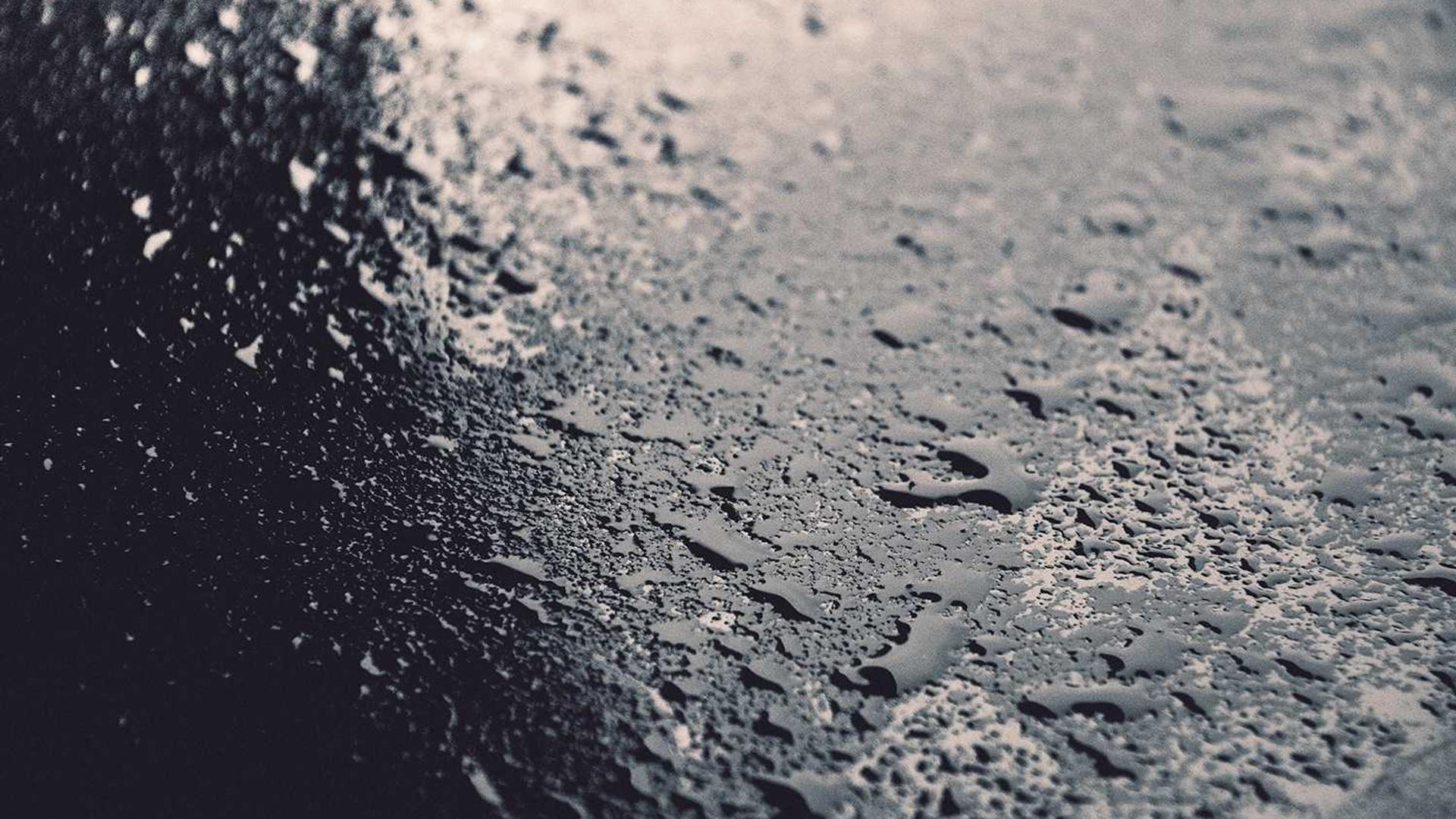 Dark macro texture of water droplets, placeholder visual for the NTNU project