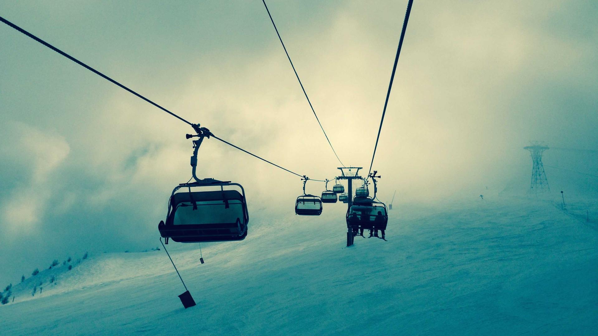 Ski lift chairs hanging in teal fog, placeholder visual for the Skypass project